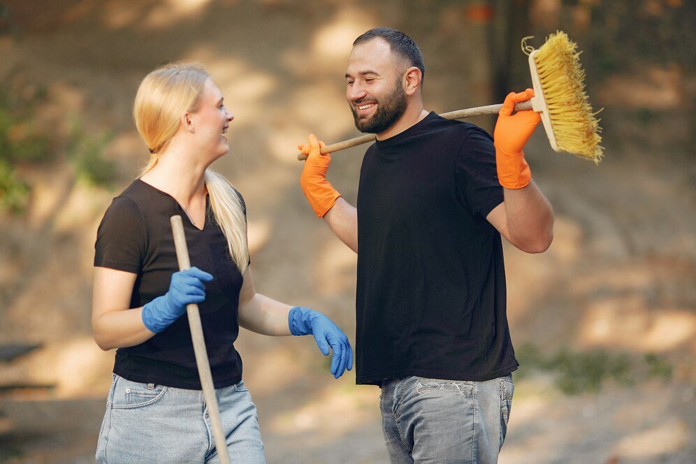 couple collects leaves cleans park 1157 27392 Builder Cleaning Experts In Edinburgh