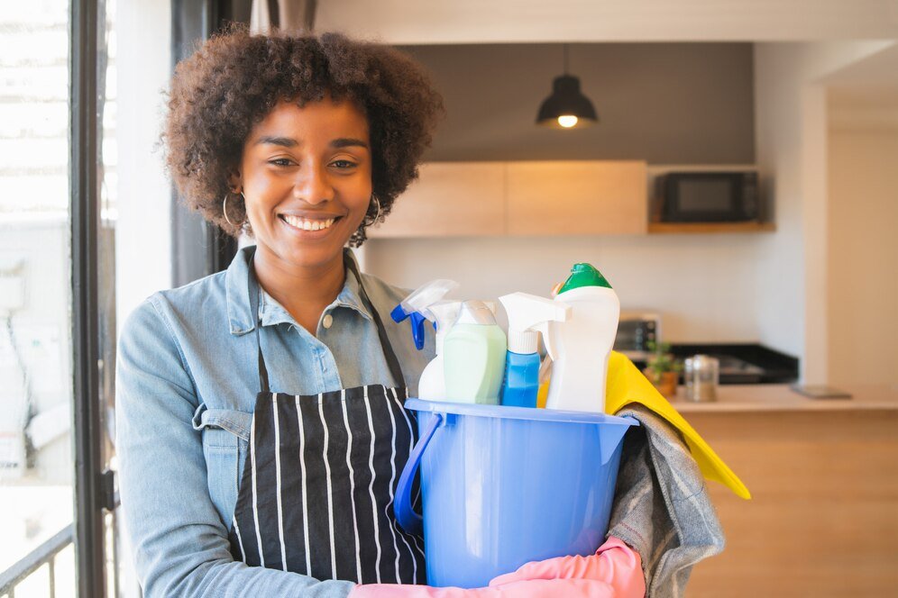 afro woman holding bucket with cleaning items 58466 11246 Cleaning Services in Edinburgh